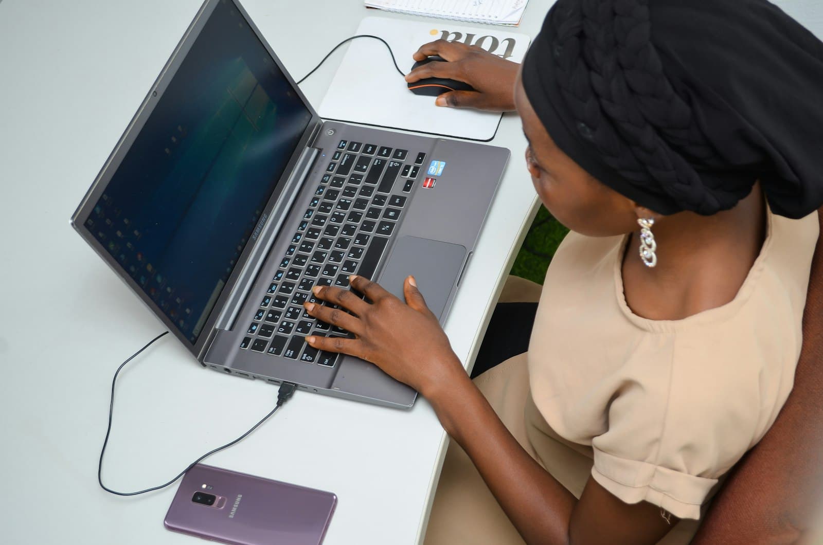 A learner typing code on a laptop